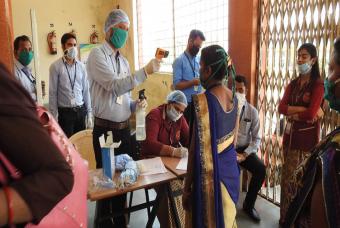 Temperature of volunteers being recorded as a precautionary measure