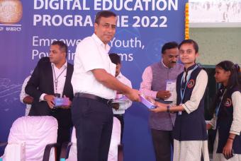 Mr Ravi Kalghatgi - VP (Support Services NTT) is all smiles while distributing the digital tablet