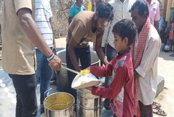 Rice, dal, and khatta (a tomato-based chutney) being served