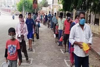People patiently wait while maintaining social distance
